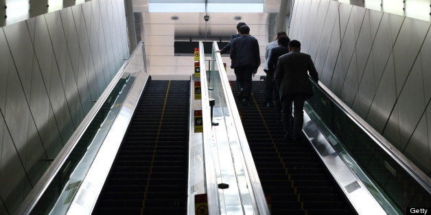 Morning commuters ride on an escalator at a subway station in Seoul, South Korea, on Monday, May 13, 2013. South Korea's unemployment rate fell to 3.1 percent in April, the lowest level in four months. Photographer: SeongJoon Cho/Bloomberg via Getty Images