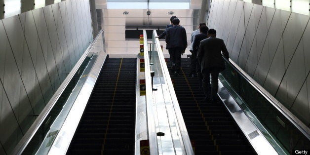 Morning commuters ride on an escalator at a subway station in Seoul, South Korea, on Monday, May 13, 2013. South Korea's unemployment rate fell to 3.1 percent in April, the lowest level in four months. Photographer: SeongJoon Cho/Bloomberg via Getty Images