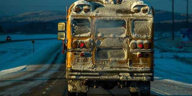 A school bus makes it's way during morning's freezing temperatures reaching bellow 25 degrees Celsius on Trans Canada Highwa