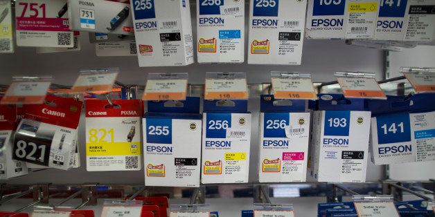 Boxes of Epson printer ink, manufactured by Seiko Epson Corp., right, are displayed for sale in a Fortress electronics store, operated by A.S. Watson & Co., in the Tsim Sha Tsui district of Hong Kong, China, on Tuesday, March 25, 2014. Temasek Holdings Ptes plan to buy a stake in the retail arm of billionaire Li Ka-shings Hutchison Whampoa Ltd. will help the investment firm extend its reach in China and ease its reliance on Singapores banks. Photographer: Jerome Favre/Bloomberg via Getty Images