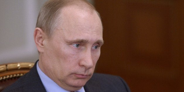 Russia's President Vladimir Putin attends a meeting in his Novo-Ogaryovo residence outside Moscow, on March 27, 2014. Putin s