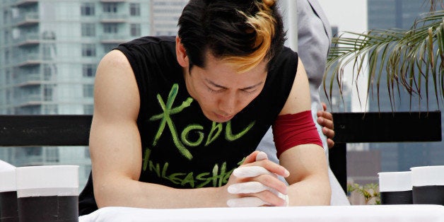 NEW YORK, NY - JULY 04: Competitive eater Takeru Kobayashi prepares to challenge 2011 Nathan's Famous Hot Dog Eating Competition Contestants via satellite at 230 Fifth Avenue on July 4, 2011 in New York City. (Photo by Cindy Ord/Getty Images)