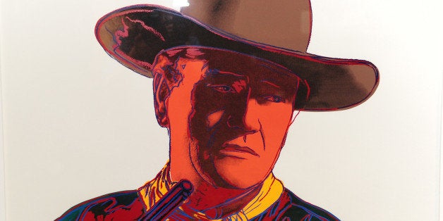 An Andy Warhol limited edition signed print from the Cowboys and Indians series (estimated price USD $20,000-$25,000) is on display at an auction preview of items owned by the iconic American film star John Wayne, October 3, 2011 in Los Angeles, California. More than 700 awards, scripts, costumes and personal memorabilia owned by 'The Duke' will be auctioned by Heritage Auctions on October 7 in Los Angeles. AFP PHOTO PHOTO / ROBYN BECK (Photo credit should read ROBYN BECK/AFP/Getty Images)