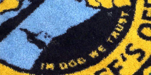 This image released by ABC Action News, shows the Pinellas County Sheriff's Office rug in Largo, Fla., Wednesday, Jan. 14, 2015. WFTS news reported that the new rugs at the sheriff's administration building say "In Dog We Trust" instead of "In God We Trust." (AP Photo/WFTS-TV/ABC Action News, Adam Winer)