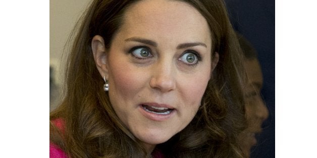 Kate Duchess of Cambridge talks to young students who are taking part in a role playing lesson about the workings of a Britis