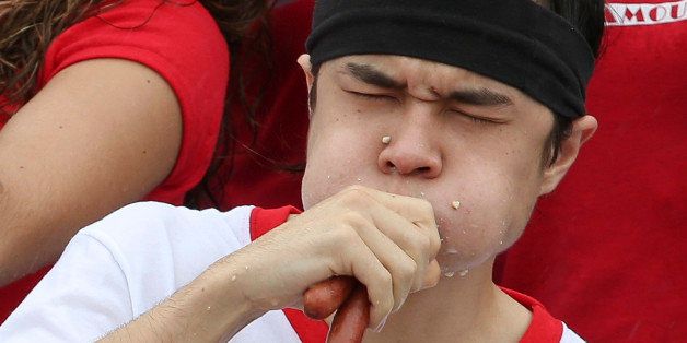 Matt Stonie competes at the Nathan's Famous Fourth of July International Hot Dog Eating contest at Coney Island, Friday, July 4, 2014, in New York. Stonie placed second against the reigning champion Joey Chestnut by eating 56 hot dogs and buns. (AP Photo/John Minchillo)