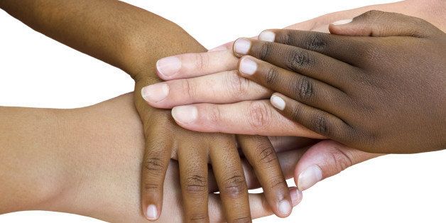 Macro close up of multiracial child hands joined together. Isolated on white background.