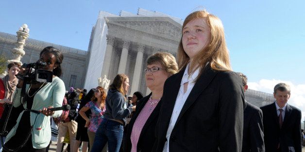 Abigail Fisher, right, who sued the University of Texas, walks outside the Supreme Court in Washington, Wednesday, Oct. 10, 2012. The Supreme Court is taking up a challenge to a University of Texas program that considers race in some college admissions. The case could produce new limits on affirmative action at universities, or roll it back entirely. (AP Photo/Susan Walsh)