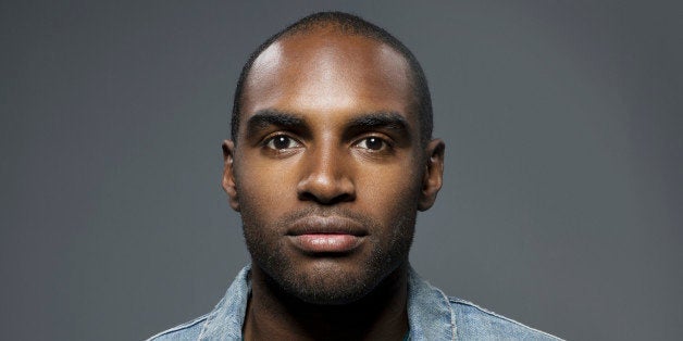 Dark skinned man looking straight into camera