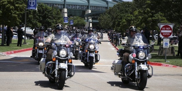 DALLAS, USA - JULY 13: Motorcycle Policemen escort the casket of slain Lorne Ahrens on the way of Restland Memorial Park's Garden of Honor cemetery in Dallas,Texas, USA on July 13, 2016. Ahrens was one of five officers killed last week when a gunman opened fire on a Black Lives Matter rally in downtown Dallas. (Photo by Bilgin S. Sasmaz/Anadolu Agency/Getty Images)