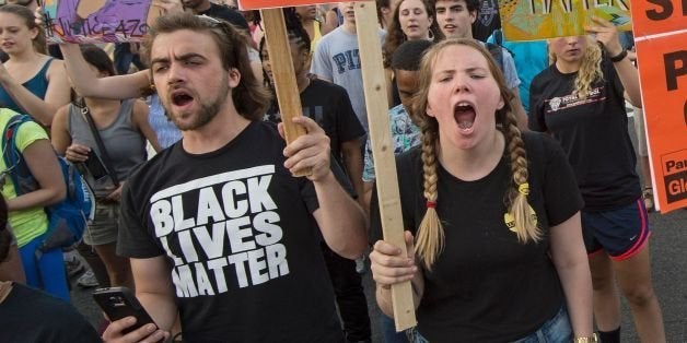 Black Lives Matter protestors shout slogans during a Black Lives Matter protest march thru the streets in Washington, DC on July 9, 2016. / AFP / PAUL J. RICHARDS (Photo credit should read PAUL J. RICHARDS/AFP/Getty Images)