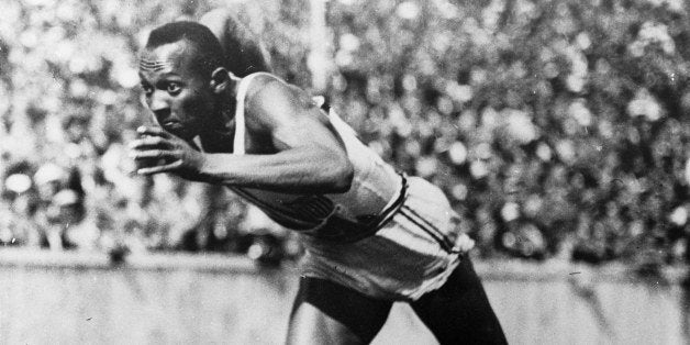 FILE - This 1936 file photo shows Jesse Owens in action in a 200-meter preliminary heat at the 1936 Summer Olympic Games in Berlin. Hop on the Underground at "Jesse Owens" station. After one stop change at "Carl Lewis." And then ride the Tube all the way to "Michael Phelps." That, sports fans, will get you from central London right to the Olympic Stadium. (AP Photo/File)