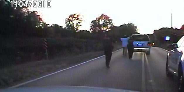 In this image made from a Friday, Sept. 16, 2016 police video, Terence Crutcher, center, is pursued by police officers as he