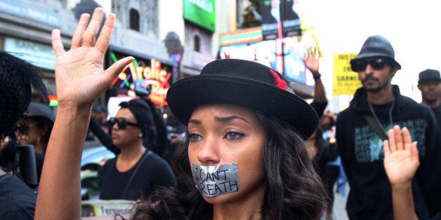 LOS ANGELES, CA - DECEMBER 6: People march on Hollywood Boulevard in protest of the decision in New York not to indict a pol