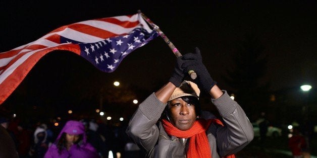 Demonstrators march in Ferguson, Missouri, on November 22, 2014, during a march to protest the death of 18-year-old Michael Brown. Tensions rose on November 22 in the troubled St Louis suburb of Ferguson, with a grand jury poised to decide whether to prosecute a white police officer for killing Brown. US President Barack Obama has called for calm, Missouri's governor declared a state of emergency and activated the state National Guard, and the FBI has deployed an extra 100 personnel in the city. AFP PHOTO/Jewel Samad (Photo credit should read JEWEL SAMAD/AFP/Getty Images)