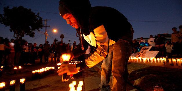 LOS ANGELES, CA - OCTOBER 2, 2016: Jeromy Jackson, lights candles for his best friend Carnell Snell Jr., 18, who was fatally shot by LAPD police Saturday after a vehicle pursuit, at at vigil in Los Angeles, Calif., on Oct. 2, 2016. The candles spell out Long Live C.J. (Photo by Gary Coronado / Los Angeles Times via Getty Images)