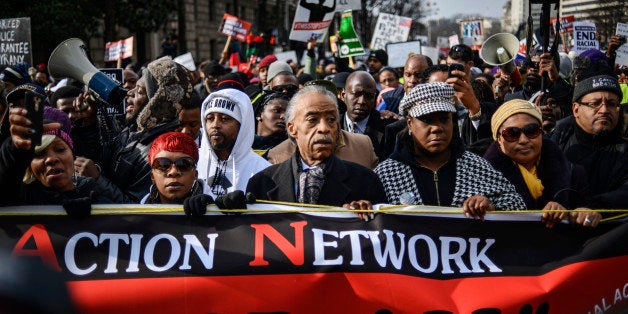 Al Sharpton (C) leads a march with family members of Eric Garner, Michael Brown, Tamir Rice and Trayvon Martin to Capitol Hill in a protest against police violence organized by the National Action Network in Washington December 13, 2014. Thousands of demonstrators gathered in Washington on Saturday for a march to protest the killings of unarmed black men by law enforcement officers and to urge Congress to do more to protect African-Americans from unjustified police violence. REUTERS/James Lawler Duggan (UNITED STATES - Tags: POLITICS CRIME LAW CIVIL UNREST)