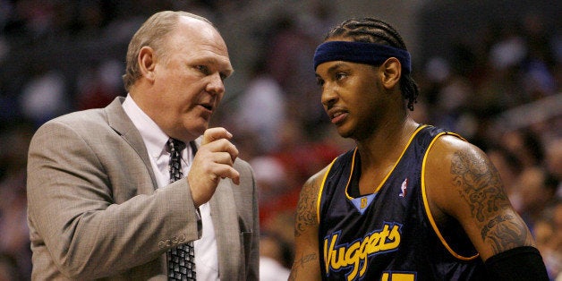 Denver Nuggets head coach George Karl (L) talks with Carmelo Anthony during a time out of their 98-87 loss to the Los Angeles Clippers in game 2 of the NBA Western Conference first round playoff series in Los Angeles, April 24, 2006. REUTERS/Danny Moloshok