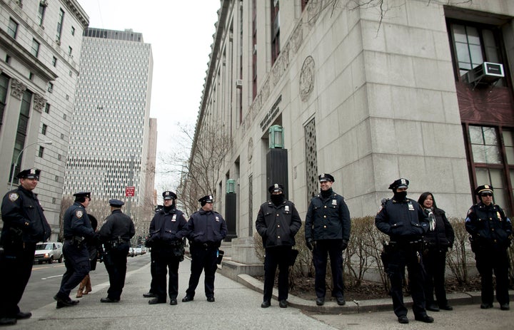 NEW YORK, NY - MARCH 18: New York CIty Police officers stand near a demonstration against the city's 'stop and frisk' searches in lower Manhattan near Federal Court March 18, 2013 in New York City. Hearings in a federal lawsuit filed by four black men against the city police department's 'stop and frisk' searches starts today in Manhattan Federal Court. (Photo by Allison Joyce/Getty Images)