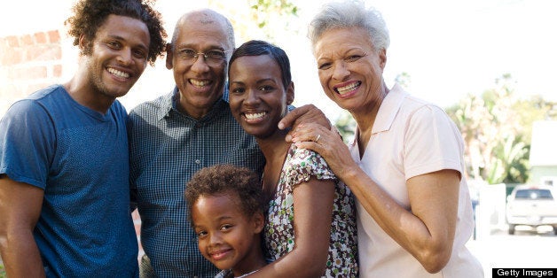 Group of five people in front of house