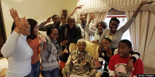 Former South African President Nelson Mandela (C) celebrate his birthday surrounded by his grandchildren during an interview with the media at his house in Qunu, on July 18, 2008. Former South African president Nelson Mandela bemoaned the growing gap between rich and poor in his country as he marked his 90th birthday. AFP PHOTO POOL Themba Hadebe (Photo credit should read THEMBA HADEBE/AFP/Getty Images)
