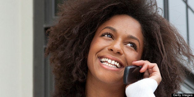 Woman using her cell phone making a purchase