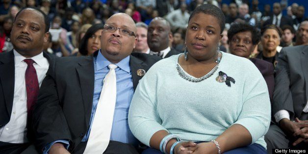 Nathaniel Pendleton and his wife Cleopatra Pendleton (R), parents of murdered Chicago teen Hadiya Pendleton, listen to US President Barack Obama speak about gun violence as well as the economy at Hyde Park Academy in Chicago on February 15, 2013. The Pendletons were guests of Obama's at the State of the Union earlier this week. AFP PHOTO / Saul LOEB (Photo credit should read SAUL LOEB/AFP/Getty Images)