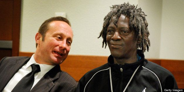 LAS VEGAS, NV - MAY 07: Rapper Flavor Flav (R) confers with his attorney Tony Abbatangelo before making an appearance at the Clark County Regional Justice Center during his arraignment on felony assault with a deadly weapon and child endangerment charges on May 7, 2013 in Las Vegas, Nevada. The entertainer, whose legal name is William Jonathan Drayton Jr., is accused of threatening his longtime girlfriend's 17-year-old son with a butcher's knife during an argument last October. Drayton is also facing a misdemeanor domestic violence battery charge. (Photo by David Becker/Getty Images)