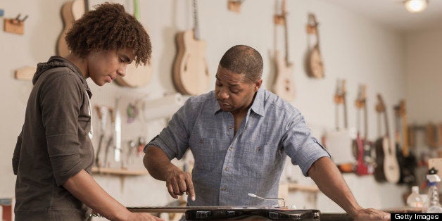 Father and son in music workshop