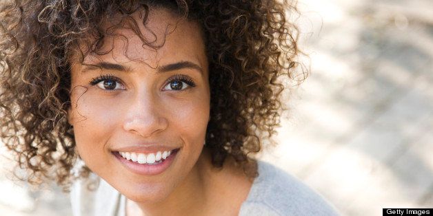 Beautiful woman with curly hair smiling