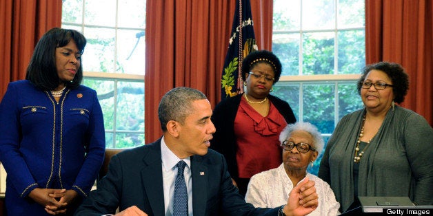 WASHINGTON, DC - MAY 24: US President Barack Obama (2nd L) speaks as he signs a bill in the Oval Office designating the Congressional Gold Medal to commemorate the four young girls killed during the 1963 bombing of 16th Street Baptist Church in Birmingham, Alabama, as (L-R) Rep Terri Sewell (D-AL), Thelma Pippen McNair, mother of Denise McNair, Lisa McNair, sister of Denise McNair, Dianne Braddock, sister of Carole Robertson, Rev Arthur Price, Jr, pastor 16th Street Baptist Church, and former U.S. Attorney Gordon Douglas Jones look on May 24, 2013 in Washington, DC. The medal, the highest Congressional civilian honor, was given posthumously to Addie Mae Collins, Carole Robertson, Cynthia Wesley and Denise McNair who died September 15, 1963 when a bomb planted bywhite supremacists exploded exploded at the church. (Photo by Mike Theiler-Pool/Getty Images