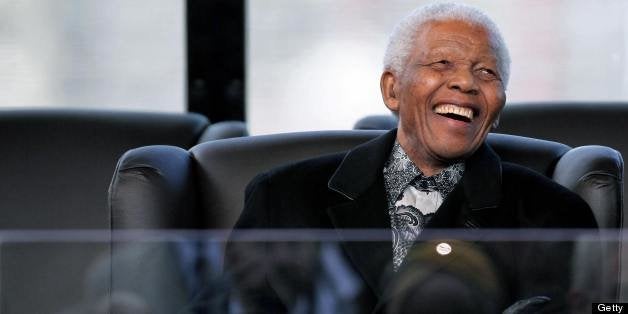 Former South African President and Nobel Peace prize laureate Nelson Mandela reacts during the inauguration of unseen Preside