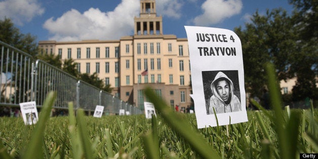 SANFORD, FL - JULY 13: A sign showing support for Trayvon Martin is stuck in the lawn in front of the Seminole County Criminal Justice Center where a jury is deliberating in the trial of George Zimmerman on July 13, 2013 in Sanford, Florida. Zimmerman, a neighborhood watch volunteer, is on trial for the February 2012 shooting death of 17-year-old Trayvon Martin. (Photo by Scott Olson/Getty Images)