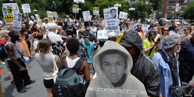 A man holds a cardboard cutout of Trayvon Martin during a demonstration in New York on July 14, 2013. Protests were held one