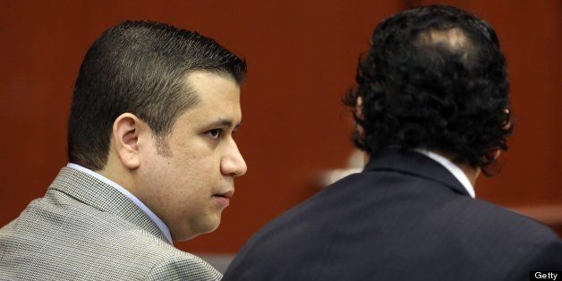 George Zimmerman talks with jury consultant Robert Hirschhorn, right, during Zimmerman's trial in Seminole circuit court in Sanford, Florida, Friday, June 14, 2013. Zimmerman has been charged with second-degree murder for the 2012 shooting death of Trayvon Martin. (Pool photo by Gary W. Green/Orlando Sentinel/MCT via Getty Images)