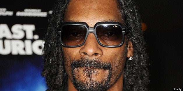 HOLLYWOOD, CA - JULY 16: Snoop Dogg aka Snoop Lion attends a screening of 'Turbo' at ArcLight Hollywood on July 16, 2013 in