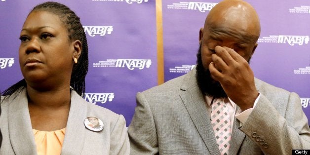 The parents of Trayvon Martin, Sybrina Fulton, left, and Tracy Martin, listen to their attorneys, during a news conference at