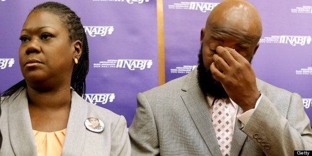 The parents of Trayvon Martin, Sybrina Fulton, left, and Tracy Martin, listen to their attorneys, during a news conference at the National Association of Black Journalists national convention, in Orlando, Florida, Friday, August 2, 2013. (Joe Burbank/Orlando Sentinel/MCT via Getty Images)