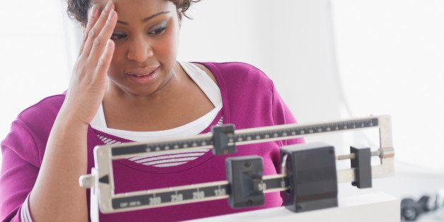 African American woman weighing herself