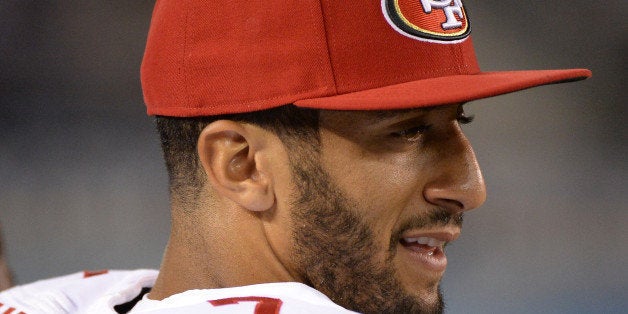 SAN DIEGO, CA - AUGUST 29: Colin Kaepernick #7 of the San Francisco 49ers smiles from the sidelines with his team leading 7-0 over the San Diego Chargers during the first quarter of a preseason game at Qualcomm Stadium on August 29, 2013 in San Diego, California. (Photo by Harry How/Getty Images)