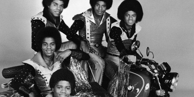 Promotional studio portrait of American pop group The Jackson 5 posing with a motorcycle, for their TV variety series, 'The Jacksons,' 1977. Michael Jackson kneels in front. (Photo by CBS Photo Archive/Getty Images) 