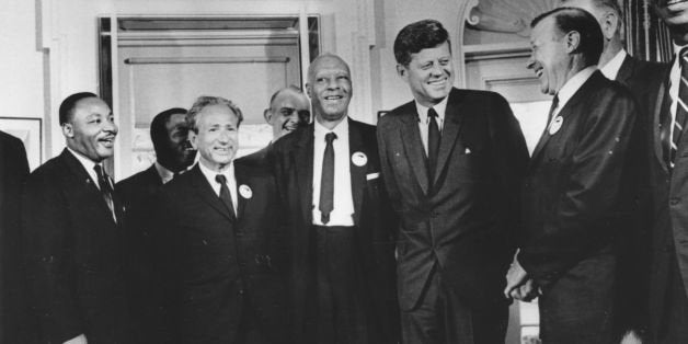 28th August 1963: American president John F. Kennedy in the White House with leaders of the civil rights 'March on Washington' (left to right) Whitney Young, Dr Martin Luther King (1929 - 1968), Rabbi Joachim Prinz, A. Philip Randolph, President Kennedy, Walter Reuther (1907 - 1970) and Roy Wilkins. Behind Reuther is Vice-President Lyndon Johnson. (Photo by Three Lions/Getty Images)