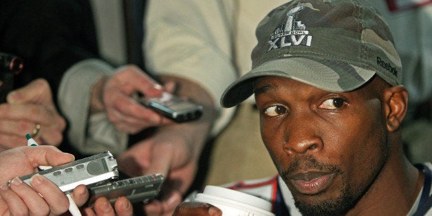 INDIANAPOLIS - FEBRUARY 1: Patriots wide receiver Chad Ochocinco sips a coffee as he listens to a reporters question. Both the Patriots and the Giants held media availabilities today. New England's was held at the University Place Conference Center and Hotel, while New York's was held at the Indianapolis Marriott Downtown. The New England Patriots will meet the New York Giants in Super Bowl XLVI on Sunday at Lucas Oil Stadium. (Photo by Jim Davis/The Boston Globe via Getty Images)