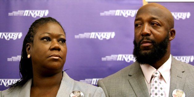 The parents of Trayvon Martin, Sybrina Fulton, left, and Tracy Martin, listen to their attorneys, during a news conference at the National Association of Black Journalists national convention, in Orlando, Florida, Friday, August 2, 2013. (Joe Burbank/Orlando Sentinel/MCT via Getty Images)