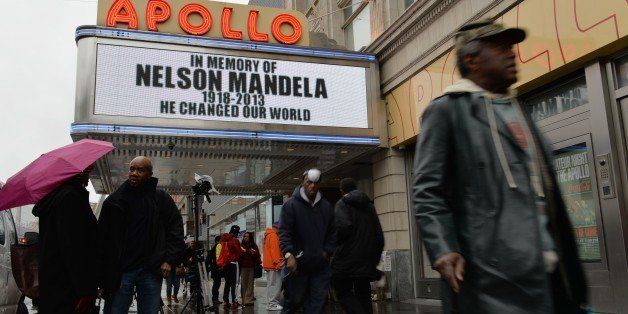 The marquee at the Apollo Theater in Harlem displays a memorial sign after the death of Nelson Mandela, former South African president and anti-apartheid leader, on December 6, 2013 in New York. The world on Friday mourned Mandela, who was hailed universally as an 'incredible gift' to humanity. Mandela's 'rainbow nation' awoke to a future without its founding father and its first black president, after he died late on December 5 aged 95 at his Johannesburg home surrounded by friends and family. AFP PHOTO/Stan HONDA (Photo credit should read STAN HONDA/AFP/Getty Images)