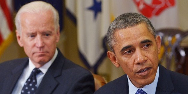 US President Barack Obama and Vice President Joe Biden meet with the Presidents Commission on Election Administration in the Roosevelt Room of the White House on January 22, 2014 in Washington, DC. AFP PHOTO/Mandel NGAN (Photo credit should read MANDEL NGAN/AFP/Getty Images)