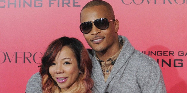 LOS ANGELES, CA - NOVEMBER 18: Rapper T.I. and wife Tameka 'Tiny' Harris arrives at the Los Angeles Premiere 'The Hunger Games: Catching Fire' at Nokia Theatre L.A. Live on November 18, 2013 in Los Angeles, California. (Photo by Jon Kopaloff/FilmMagic)