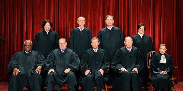 The Justices of the US Supreme Court sit for their official photograph on October 8, 2010 at the Supreme Court in Washington, DC. Front row (L-R): Associate Justice Clarence Thomas, Associate Justice Antonin Scalia, Chief Justice John G. Roberts, Associate Justice Anthony M. Kennedy and Associate Justice Ruth Bader Ginsburg. Back Row (L-R): Associate Justice Sonia Sotomayor, Associate Justice Stephen Breyer, Associate Justice Samuel Alito Jr. and Associate Justice Elena Kagan. AFP PHOTO / TIM SLOAN (Photo credit should read TIM SLOAN/AFP/Getty Images)