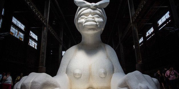 NEW YORK, NY - MAY 10: Kara Walker's 'A Subtlety,' a seventy-five and a half feet long and thirty-five and a half feet tall sphinx made in part of bleached sugar, is displayed at the former Domino Sugar Refinery on May 10, 2014 in the Williamsburg neighborhood of the Brooklyn borough of New York City. The show opened today, is free to the public and will run until July 6th. (Photo by Andrew Burton/Getty Images)