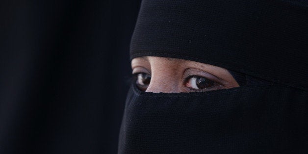 LONDON, ENGLAND - APRIL 11: A woman wears an Islamic niqab veil stands outside the French Embassy during a demonstration on April 11, 2011 in London, England. France has become the first country in Europe to ban the wearing of the veil and in Paris two women have been detained by police under the new law. (Photo by Peter Macdiarmid/Getty Images)